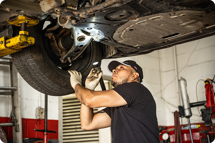 Mechanic looking under car