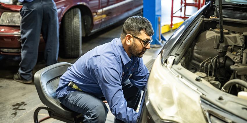 An automotive technician works on vehicle at a Metro Motor auto repair shop in D.C.