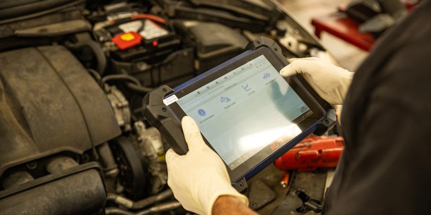 An ASE-certified technician inspects a vehicle