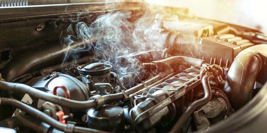 Steam rises from an overheating engine that needs auto repair