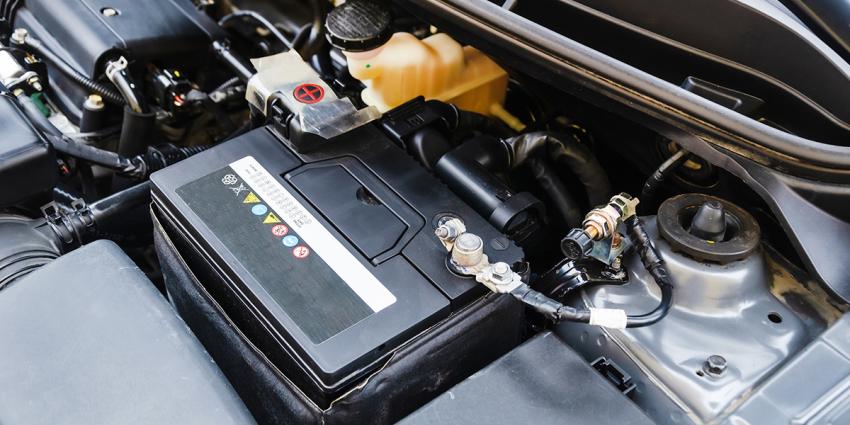 Installed car battery is shown under a vehicle's open hood