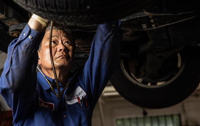 Auto repair technician works under a vehicle in Washington DC